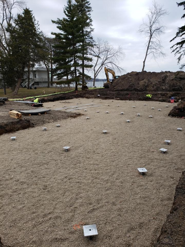 Completed helical pile cap grid prepared for a building foundation