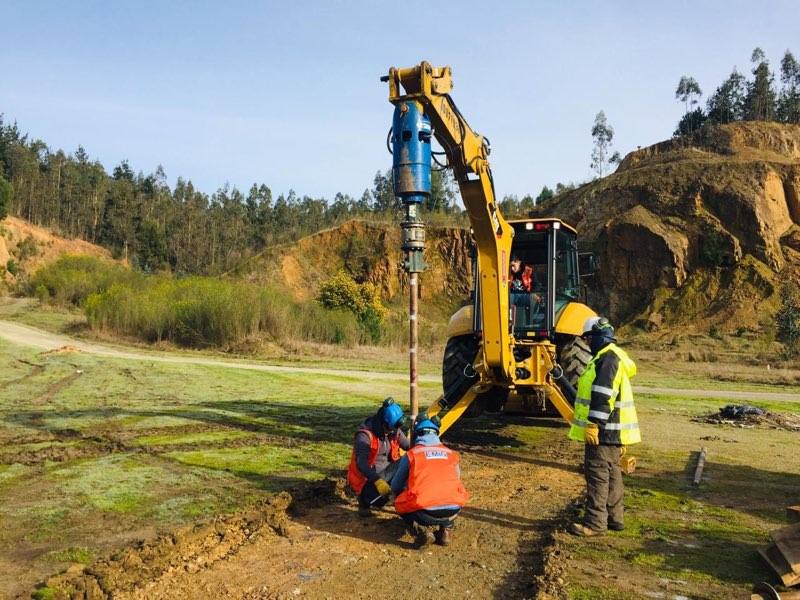 Field crew monitoring a helical test pile installation in Chile